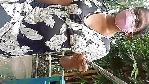 Skinny brunette is on the grass outdoors and smiling